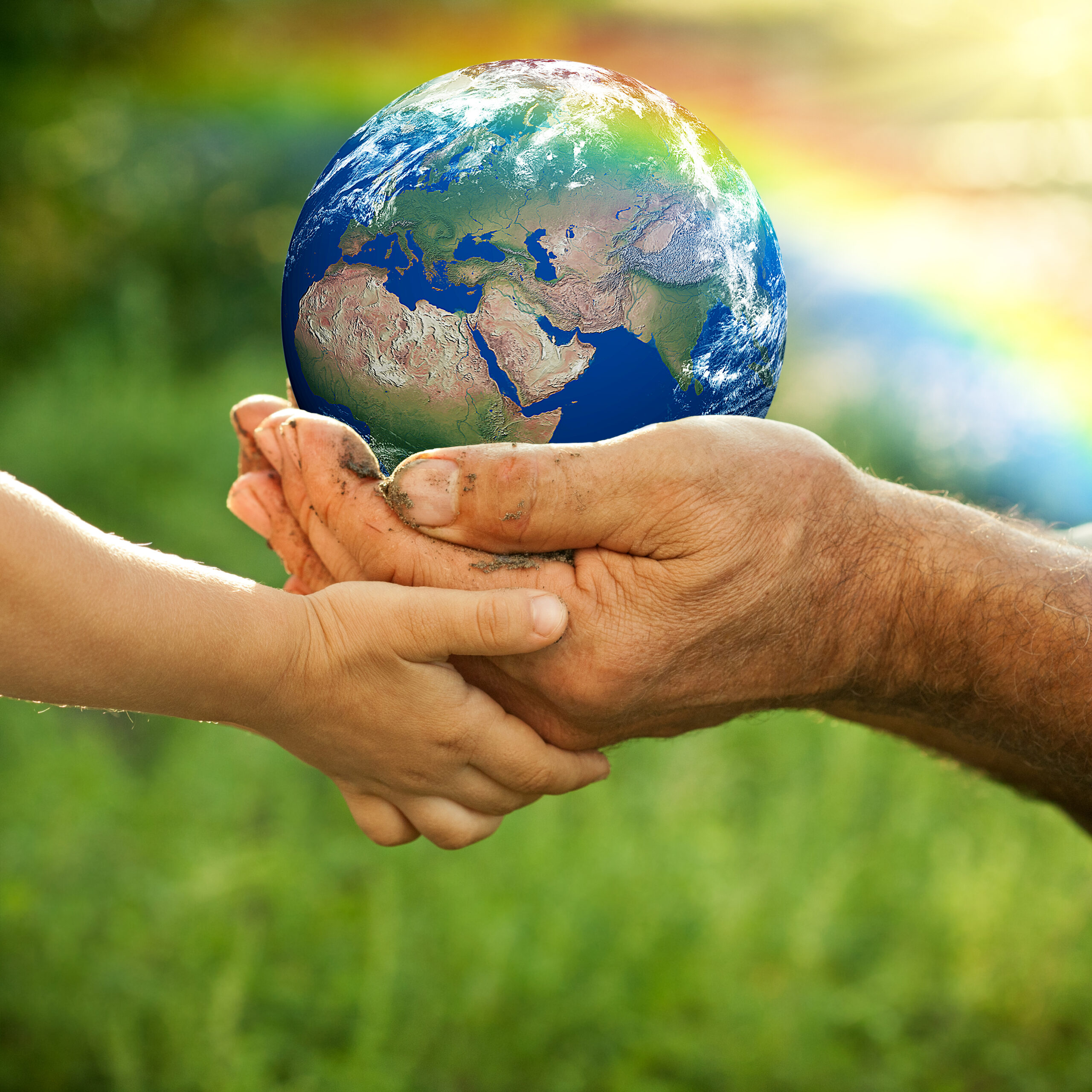 senior hands and baby hands holding Earth_iStock-155920904